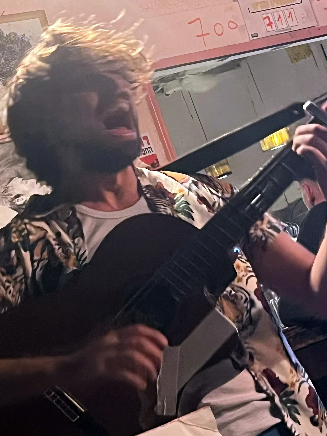 War Darling playing guitar in an intimate crowded venue