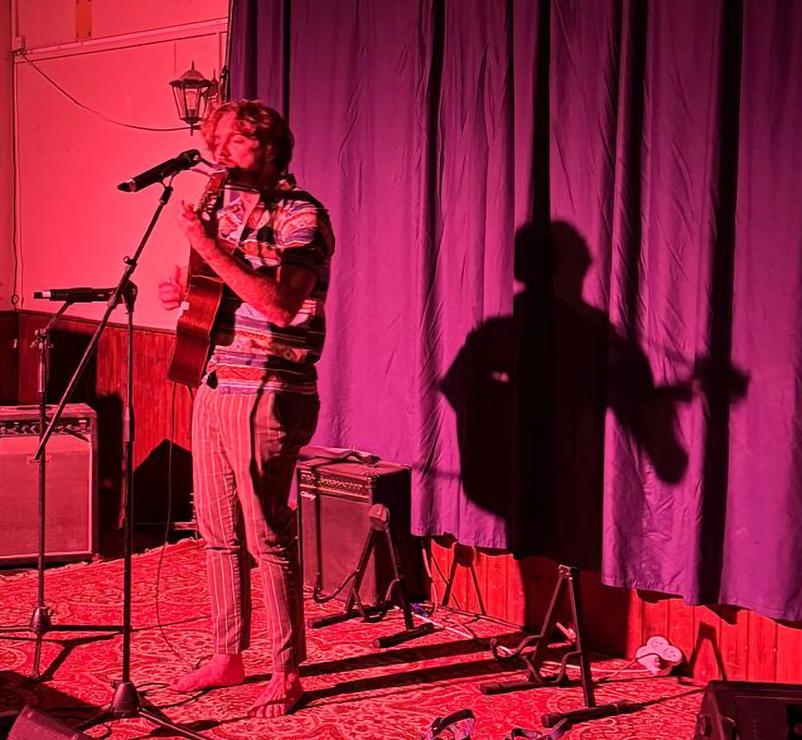 War Darling performing on a red-lit stage